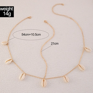 Detail view of gold head chain with shell pendants and size dimensions of 54cm and 21cm