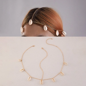 Detail of bohemian gold chain headpiece with white seashell charms and adjustable clasp