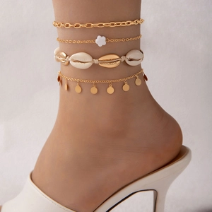 Bohemian four-piece shell anklet set with gold chains and seashell charms for beach wear