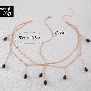 Detail showing exotic gold layered forehead chain with black teardrop rhinestones
