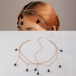 Close-up of golden multi-layer head chain with black teardrop beads on female model
