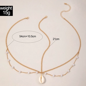 Detail of boho gold hair chain with pearls and a shell pendant showing size measurements