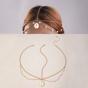 Detail of bohemian gold head chain with white pearls and a seashell pendant