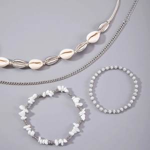 Detailed view of bohemian layered shell anklet set with natural cowrie and silver beads