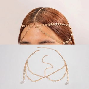 Detail of bohemian gold chain headpiece with layered metal discs and white pearls