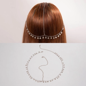 Detail view of silver bohemian forehead chain with metallic fringe disks on hair