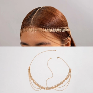 Detail of gold pearl chain headpiece with leaf pendants in bohemian style fashion