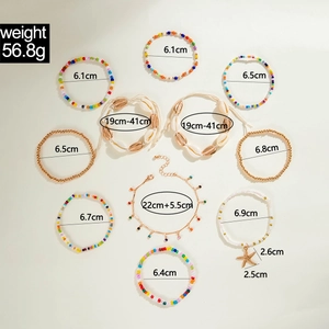 Flat lay of a 10-piece beach style jewelry set with beads, shells and starfish pendants