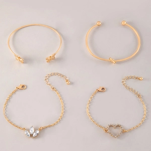 Detailed set of four gold-colored bracelets featuring butterfly, knot, leaf, and heart charms