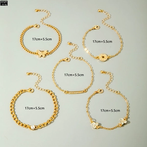 Detailed view of 5-piece gold bracelet set with heart, butterfly, and leaf motifs