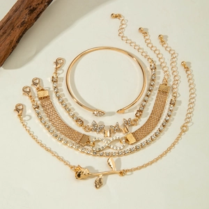 Detail of 6-piece gold-tone bracelet set with diamond heart, leaf and butterfly charms