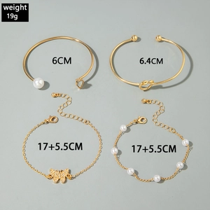 Detail view of gold-plated 4-piece set including butterfly charm bracelets and knot bangles