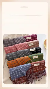 Detail of plaid scarves with fringe tassels and Elegant & Classic woven labels