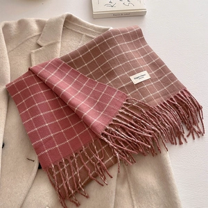 Pink and brown plaid scarf with tassels and Elegant & Classic text on beige coat