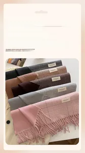 Detail of diverse checkered scarves with fringes showing soft texture and multiple color options