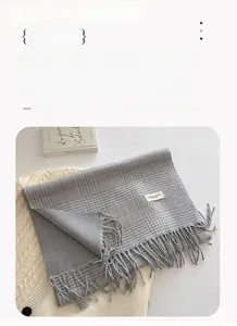 Detailed view of grey plaid tassel scarf with 202x42CM dimensions and soft texture