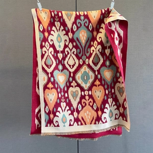 Close-up of retro geometric heart print scarf with detailed ethnic fringe and woven texture
