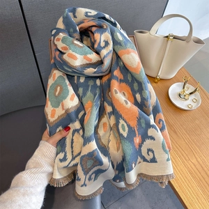 Detail of cashmere feel shawl with paisley geometric print and elegant fringe edges