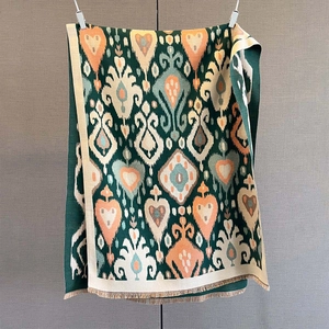 Detail of cashmere feel scarf with vintage paisley jacquard and fringed edges