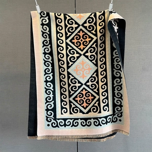 Detailed view of bohemian geometric pattern shawl with fine fringe and knitted texture