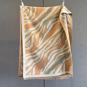Detailed view of paisley zebra print cashmere-feel shawl with elegant tassel fringe edge