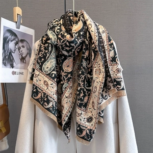 Detail of vintage paisley pattern scarf with fine fringe on a white winter coat
