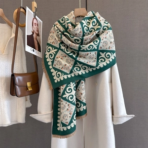 Close-up of jacquard floral scarf with fringes styled over a white autumn coat