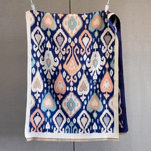 Detailed view of bohemian ikat pattern scarf with thick woven texture and fringed edges