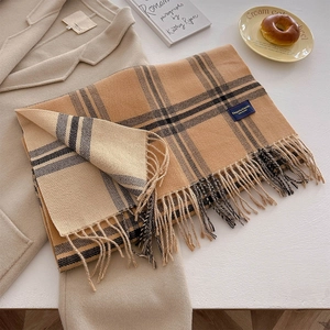 Detail of plaid scarf with thick fringe and Elegant & Classic blue woven label