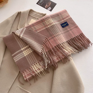 Classic British style plaid scarf with pink and brown fringe tassels on wool coat