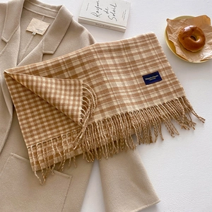 Plaid checkerboard scarf in beige and brown with tassels paired with a wool coat