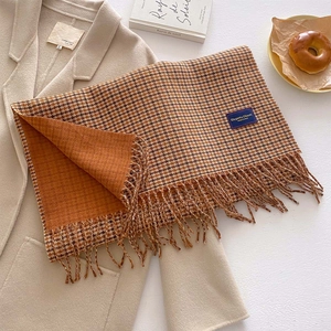 Classic houndstooth winter scarf in orange and brown with thick fringe detailing