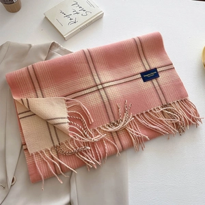 Pink and beige plaid cashmere-feel scarf with fringe, laid over a stylish beige blazer