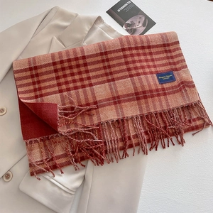 Thick red and white plaid cashmere-like scarf with tassels on beige blazer