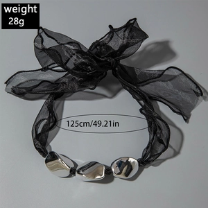 Detail of 125cm black tulle ribbon necklace with metallic beads weighing 28g