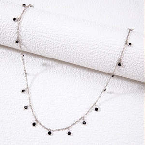Detail of silver chain necklace with black beads and adjustable lobster clasp closure