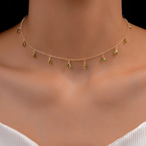 Minimalist gold choker necklace featuring ten emerald green teardrop gemstone pendants