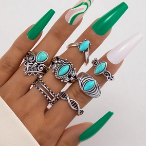 Detailed view of 7-piece bohemian ring set with turquoise and retro silver finishes