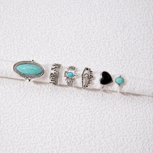 Detail view of 6-piece silver vintage bohemian rings with turquoise and eagle motifs
