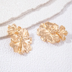 Modern gold-plated large flower petal earrings with textured metal finish on stone