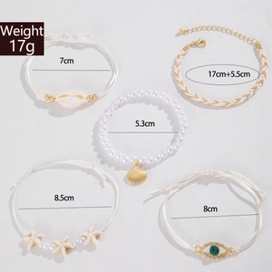 Detail of 5-piece Bohemian shell anklet set with starfish and evil eye charms