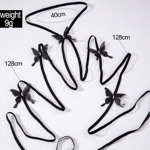Detail view of butterfly leg chain with 128cm strap and sparkling rhinestone details