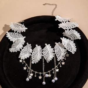 Close-up of white lace leaf choker with butterfly charms and faux pearl pendant detail