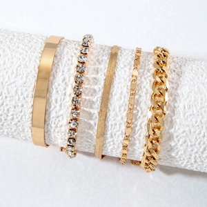 Five-piece set of gold-tone women's bracelets including curb chain and tennis bracelet