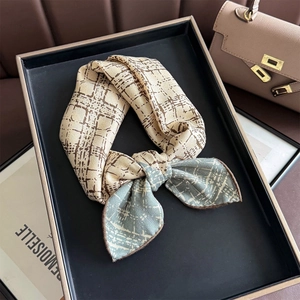 Élégant foulard en soie à motif losanges beige et bleu clair noué en joli nœud