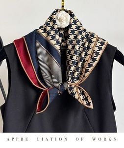 Detail of houndstooth silk wool scarf with geometric color block and hand-rolled edges