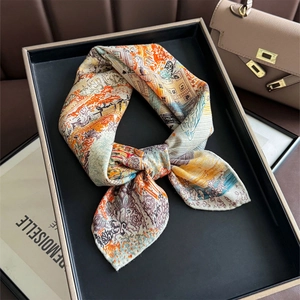 Detailed macro view of the colorful artistic printed silk wool scarf tied in a bow