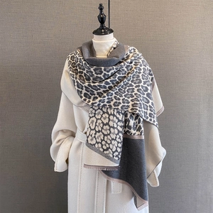 Detail view of leopard print scarf with soft knit texture and short fringe edges