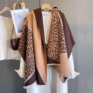 Detail of leopard print patchwork scarf with fine fringe edges and thick texture
