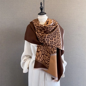 Detail of leopard print contrast scarf with soft fringe edges and thick warm texture